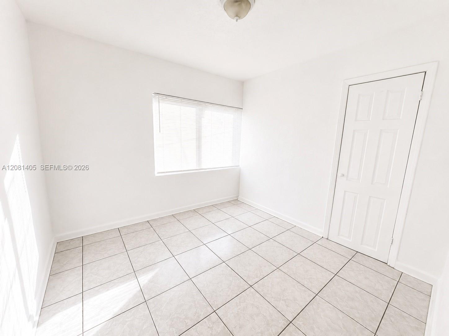 Bright bedroom with tile flooring