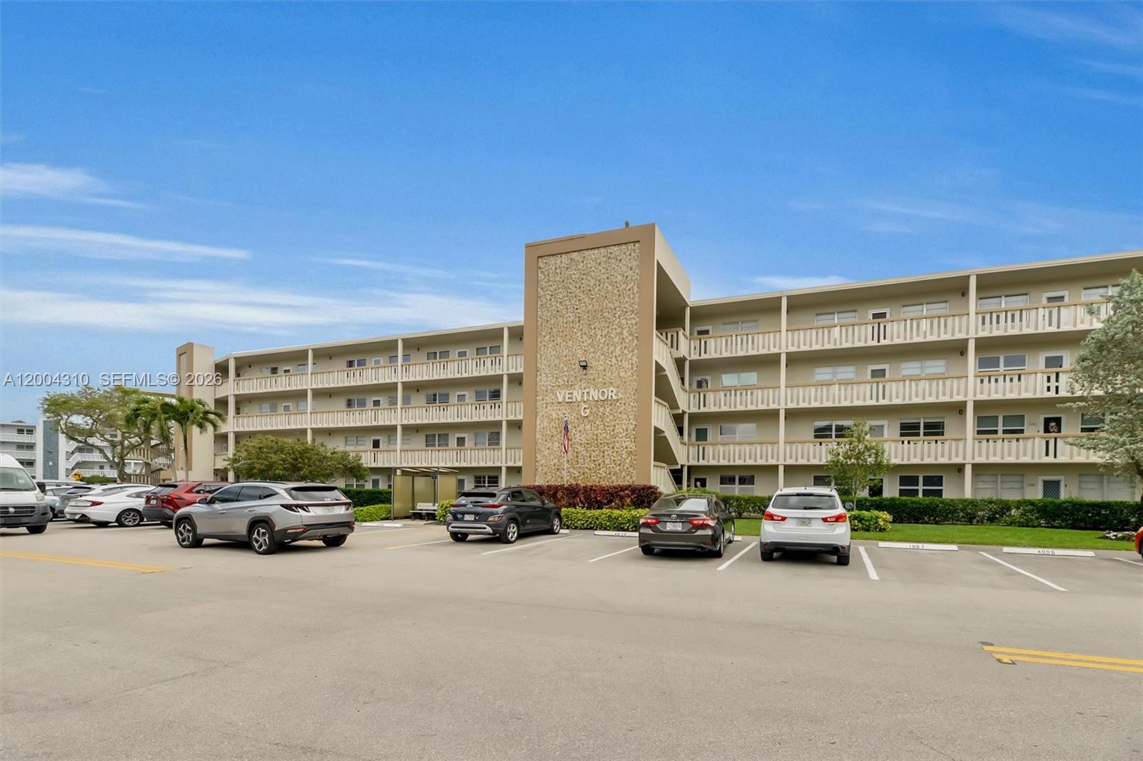 Wide building front showing full length, & parking