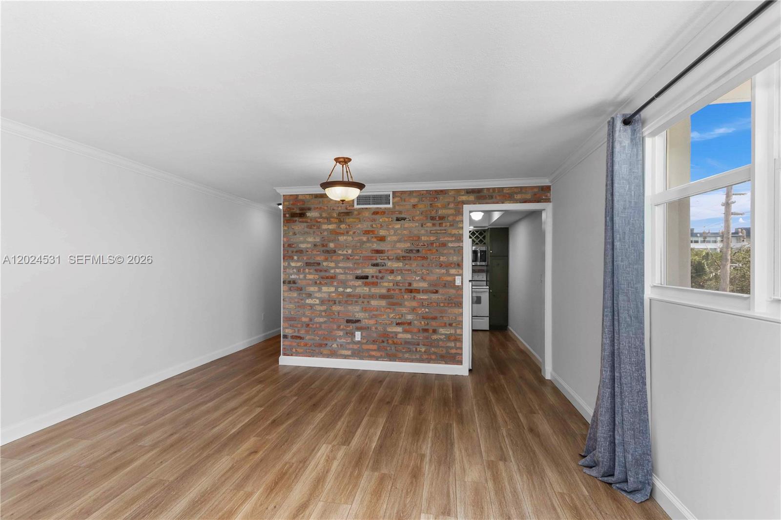 Facing the hallway to room on the left and kitchen on the right