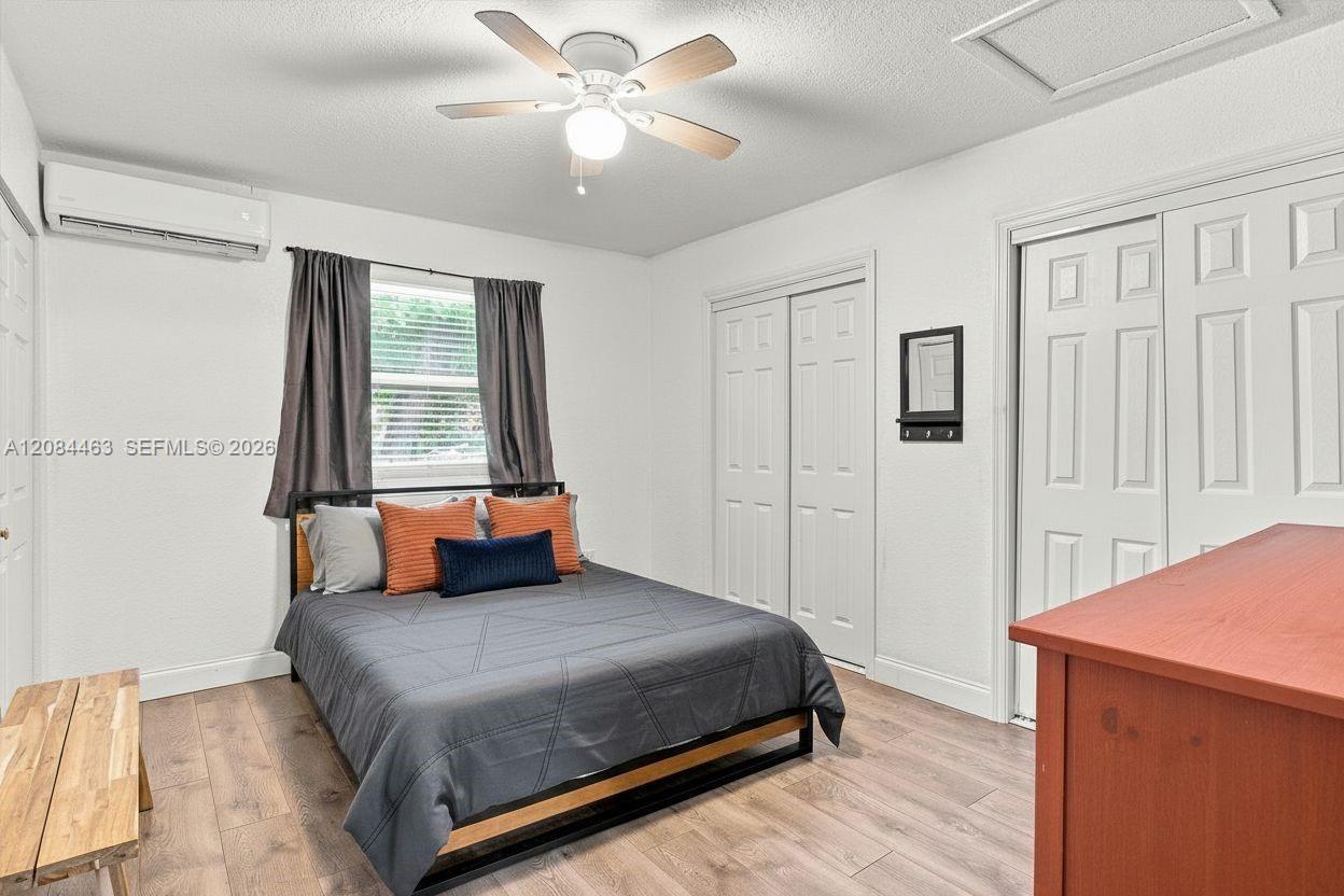 Fully furnished bedroom featuring a comfortable bed, dresser, and tasteful furnishings, creating a cozy and move-in-ready retreat