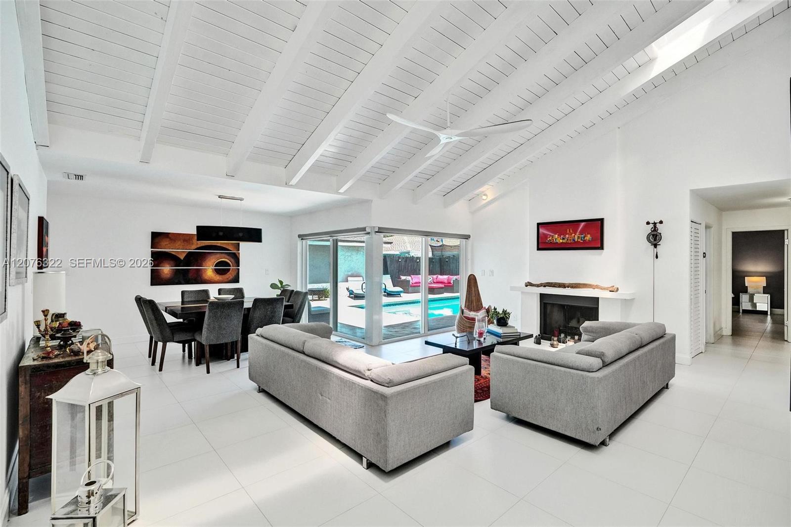 Wow! Vaulted Ceilings, fireplace, gorgeous flooring, view to pool deck, skylights.  IMPACT WINDOWS.