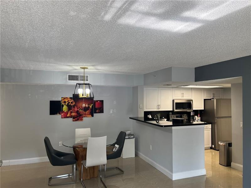 5051 WILES Road # 207 — Photo 3