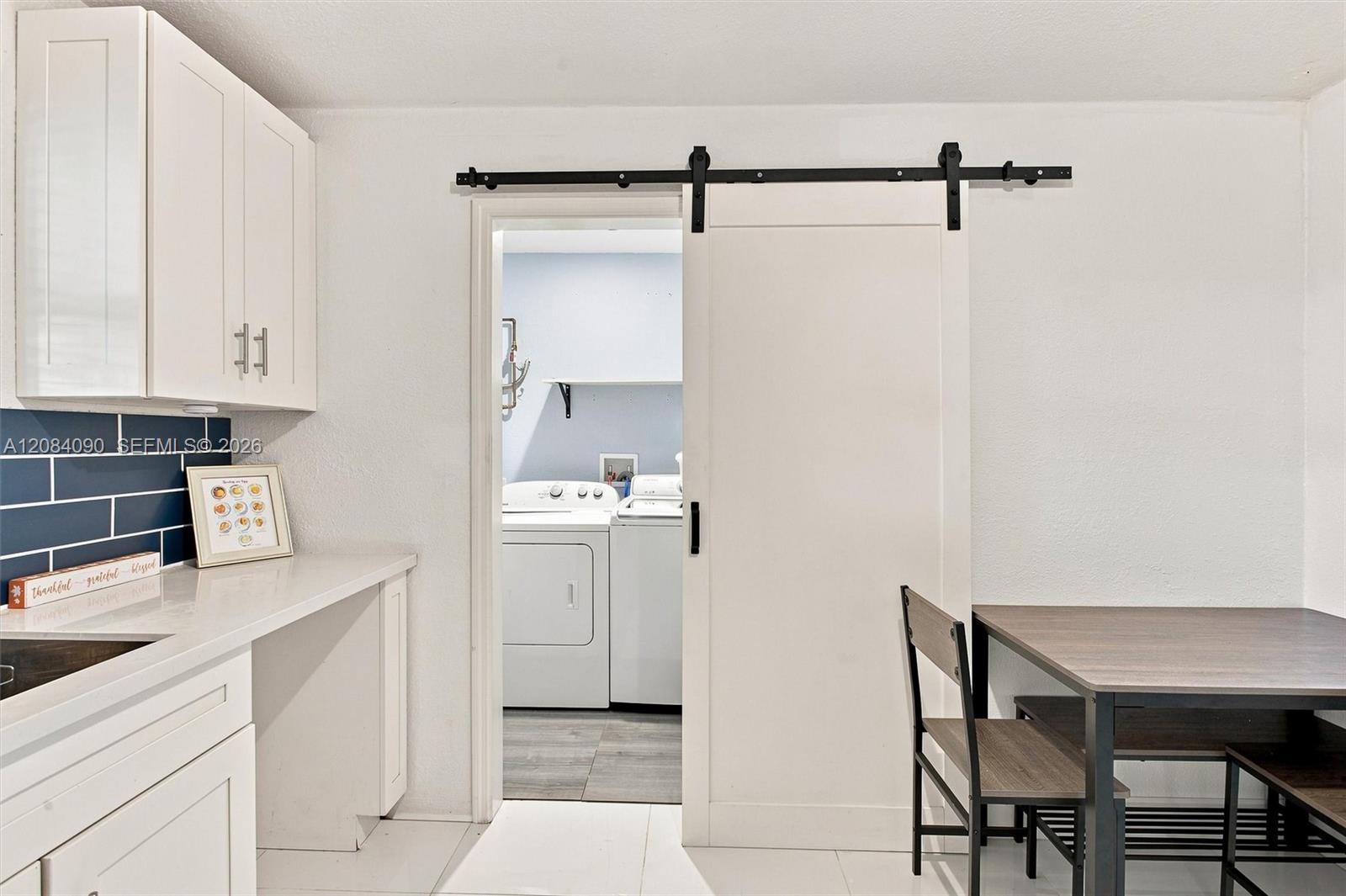 Large laundry room with plenty of storage next to kitchen