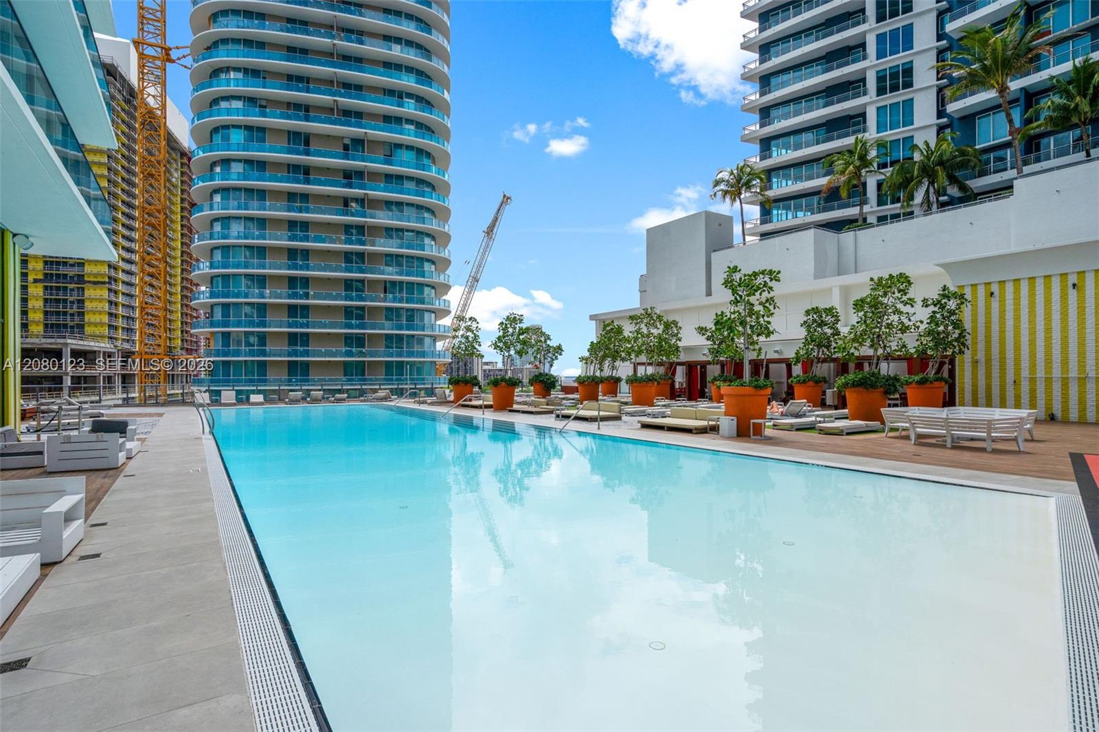 Resort-style pool with cabanas and signature SLS striped accents at SLS Brickell Dua.