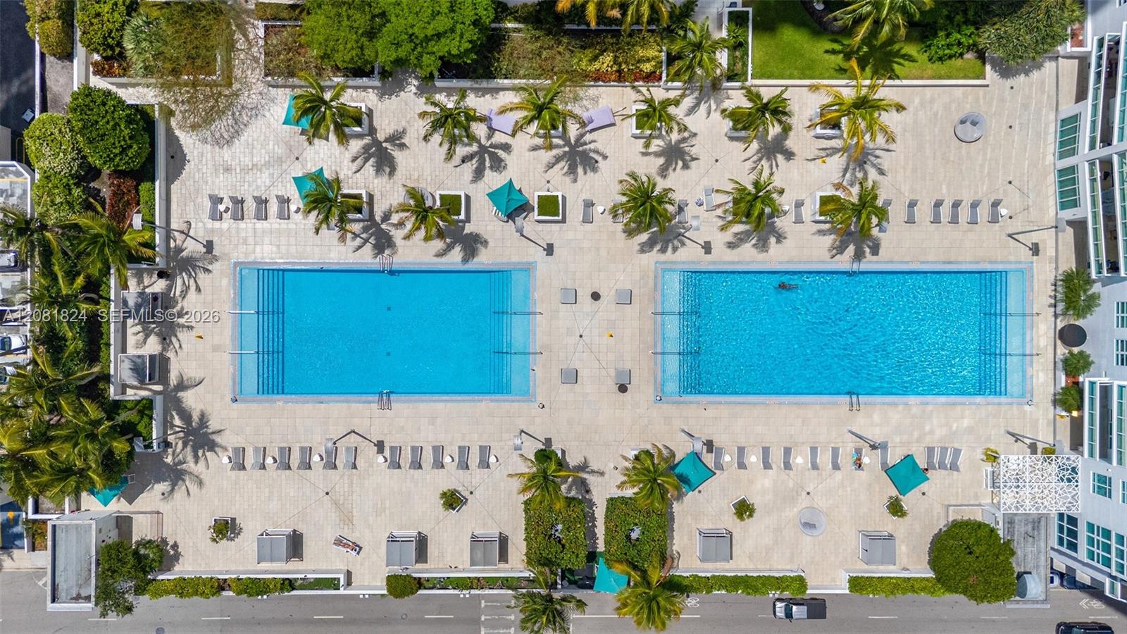 Spacious pool deck with two resort style pools and jacuzzi and BBQ area