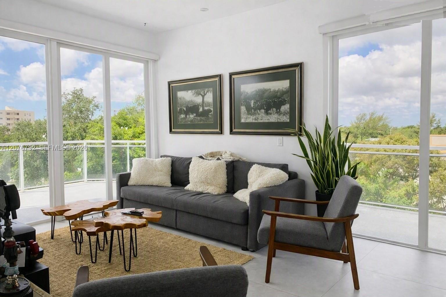 large living room dining room combo with two sets of impact glass slideing doors