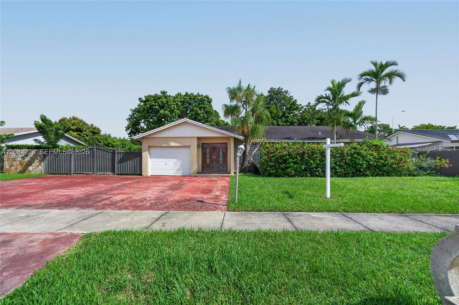 Spacious driveway with a metal gate