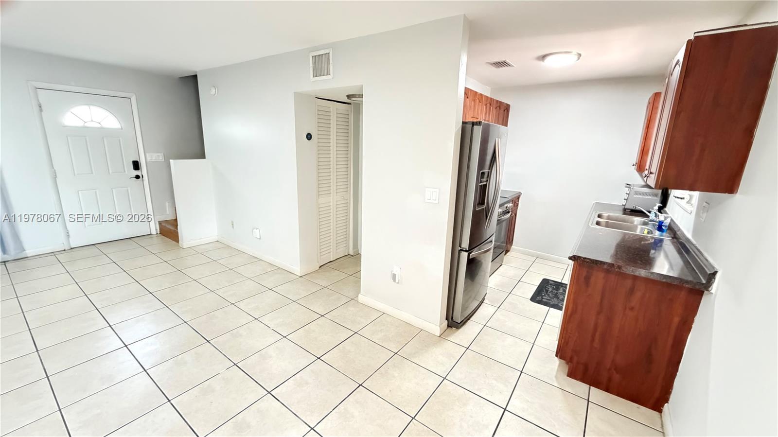 Kitchen and entrance to Den w/Bathroom