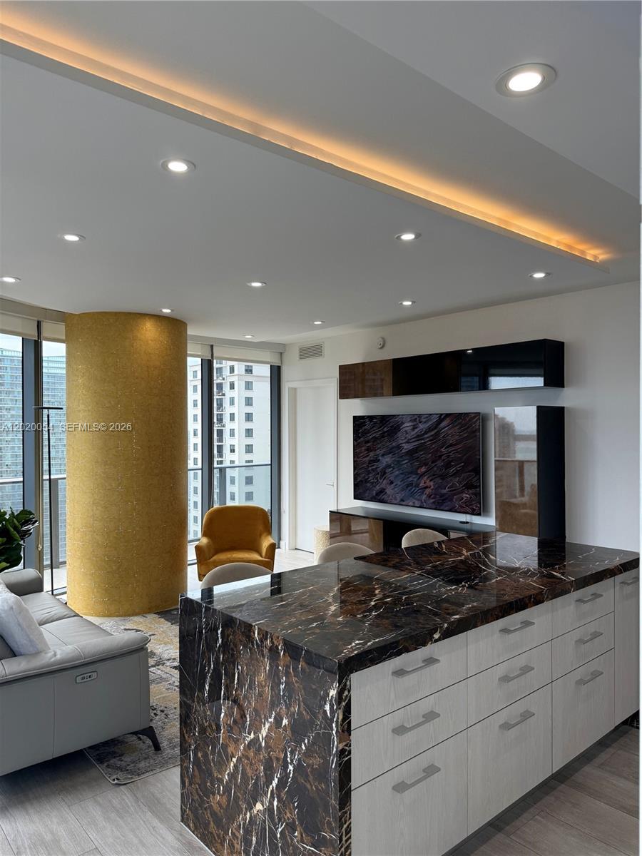 Lovely Marble countertop, recessed lighting, tons of natural light coming in from wraparound, floor to ceiling windows.