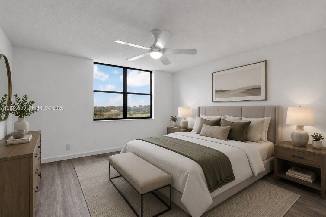 Generously sized primary bedroom featuring large windows framing serene water views. Virtually staged.