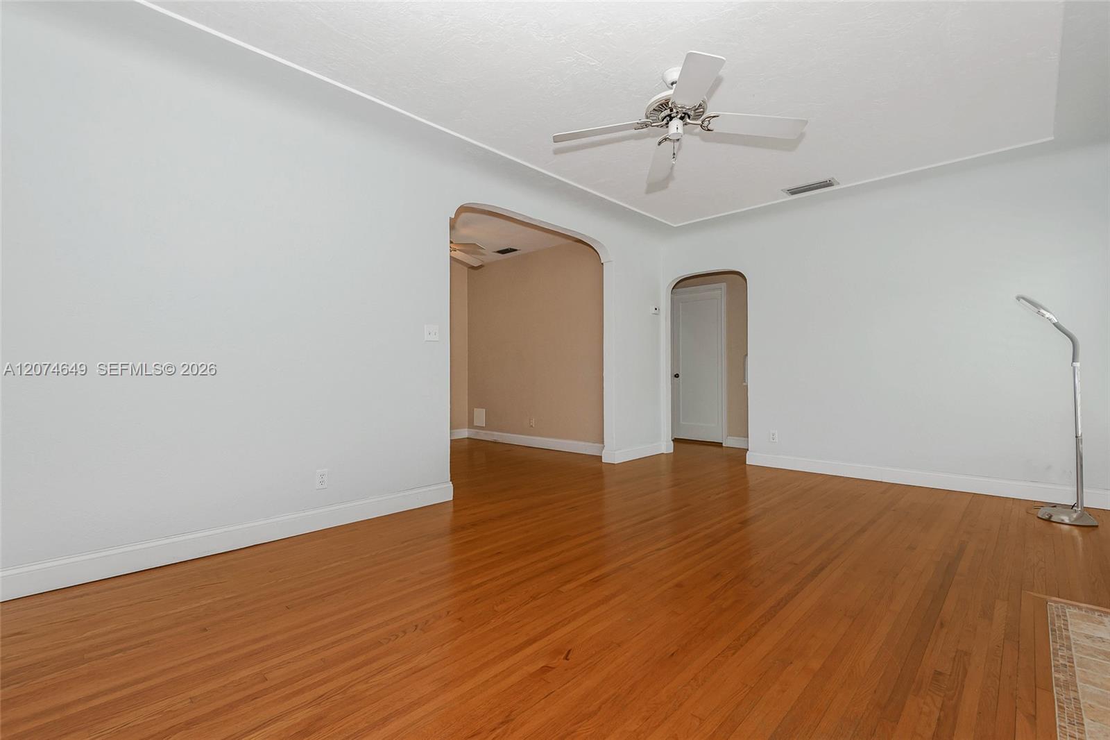 This is from the living room front wall toward the open entry to the eat-in kitchen and the hall to the Primary bedroom and bathroom area.