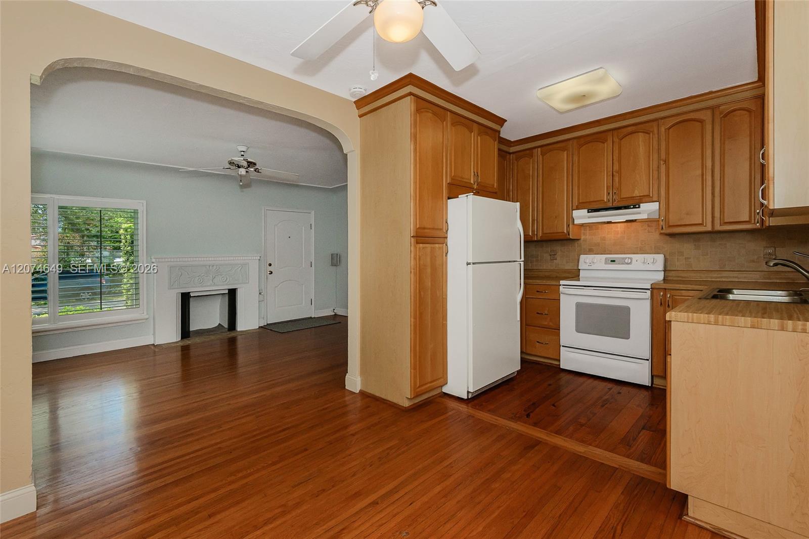 Here is the eat-in area of the kitchen looking back into the living room and at many of the cabinets within the kitchen.